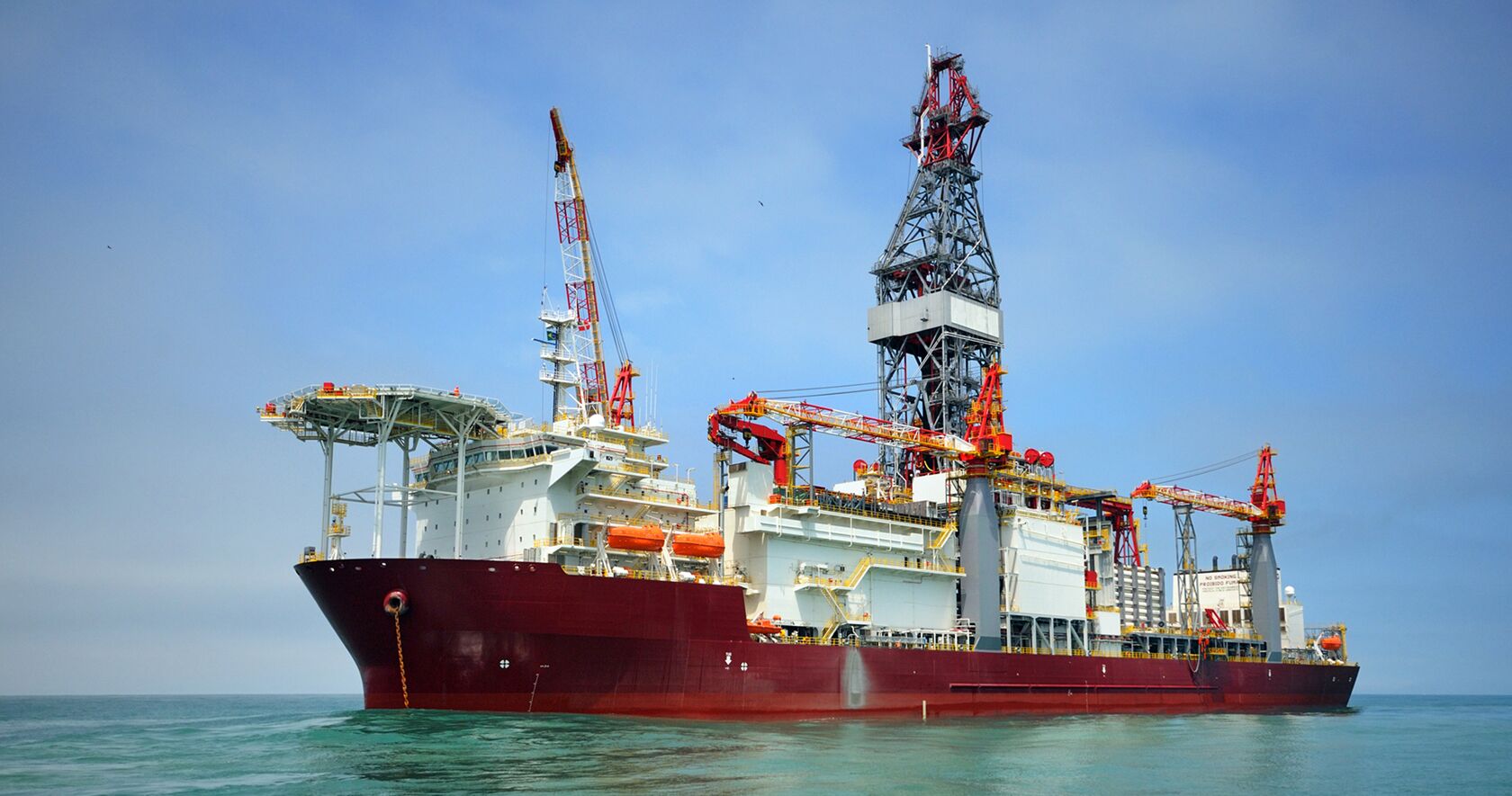 An offshore rig removing items from a supply vessel. 